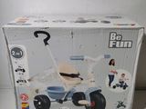 a box that has a toy tricycle inside of it