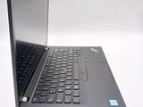a laptop with a black keyboard sitting on a white surface
