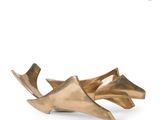 gold leaf shaped bowl on a white surface with a white background