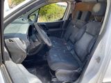 the interior of a car with the door open and the seats down