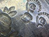 a close up of a silver plate with flowers on it