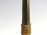 a tall candle that is sitting on top of a table