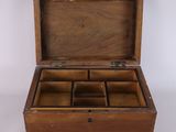 an old wooden box with six compartments on a white surface