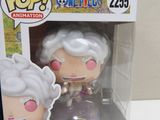 funko pop vinyl figure of a woman with a white hair and pink eyes in a box