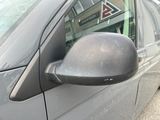 a side view mirror of a car that is parked on the side of the road