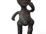 figurine in the form of a man with a hat on his head and hands on his head