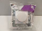 a white button on a white surface in a plastic bag