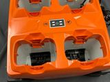 an orange box with four batteries inside of it