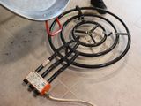 a stove top with a wire on it and a wire plugged into the burner