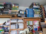 a room full of books and dvds on the shelves