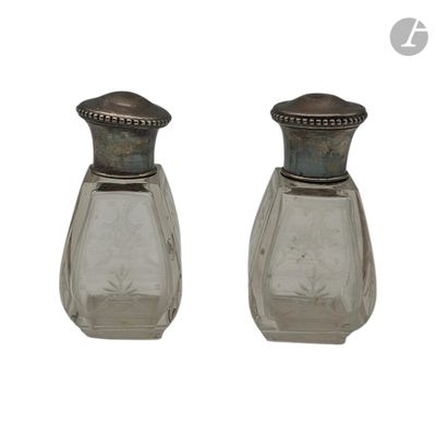 two glass salt and pepper shakers on a white background
