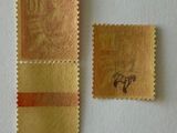 a small piece of paper with a stamp on it next to a small piece of cloth
