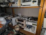 many sewing machines on the shelves in the room