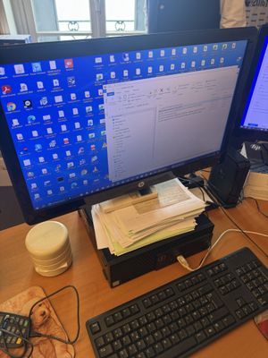 a computer desk with two monitors and a keyboard on it