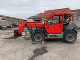 a red tractor that is parked in a parking lot