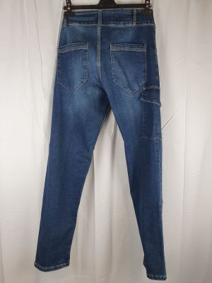 a pair of jeans hanging on a hanger on a white curtain