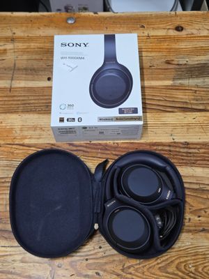 a box of headphones sitting on a wooden table