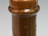 a close up of a brown vase with a tag on it