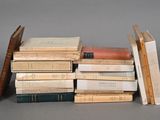 many books stacked on top of each other on a table