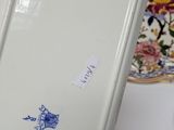 a white refrigerator with a blue sticker on it