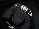 the black purse is sitting in the black box