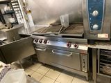 a large commercial kitchen with a lot of stainless steel appliances