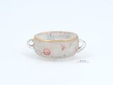 a small cup with a handle on a white surface