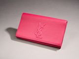 a pink clutch bag with the ysl logo on it