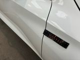 a close up of a car door with a clock on it