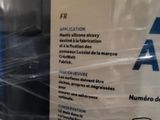 a sign on the back of a refrigerator that is wrapped in plastic
