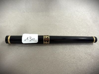 a pen with a tag on it sitting on top of a table