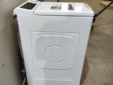 an image of a white washing machine in a warehouse