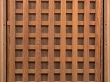 an old wooden door with a lattice pattern on the outside