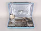a blue case with silverware in it on a white surface