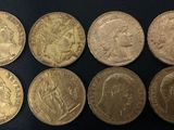 six different types of gold coins on a black surface