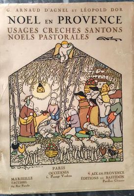 un vieux livre sur lequel figure une illustration représentant une crèche