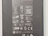 the back side of a laptop power adapter with the power cord attached