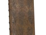 an old book is sitting on a white surface with a white background