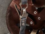 a close up of a helmet with a leather strap on it