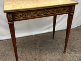 a wooden table with a marble top and legs