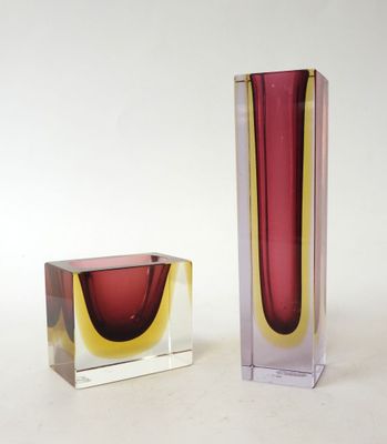 two vases sitting next to each other on a table