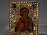 an image of a gold and enamel icon of the mother and child