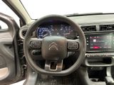 the interior of a car with a steering wheel and dashboard controls
