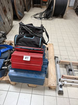 a lot of tools sitting on a pallet on the floor