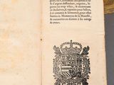 an open book with a picture of a coat of arms on it