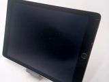 a tablet that is sitting on a stand on a table