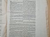 a book open on a table with papers on it