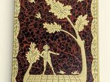 an antique cigarette case with a picture of a woman and a tree on it