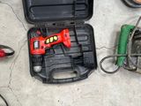 a tool box with tools on the floor next to a pair of shoes