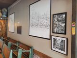 many pictures hanging on the wall of this restaurant
